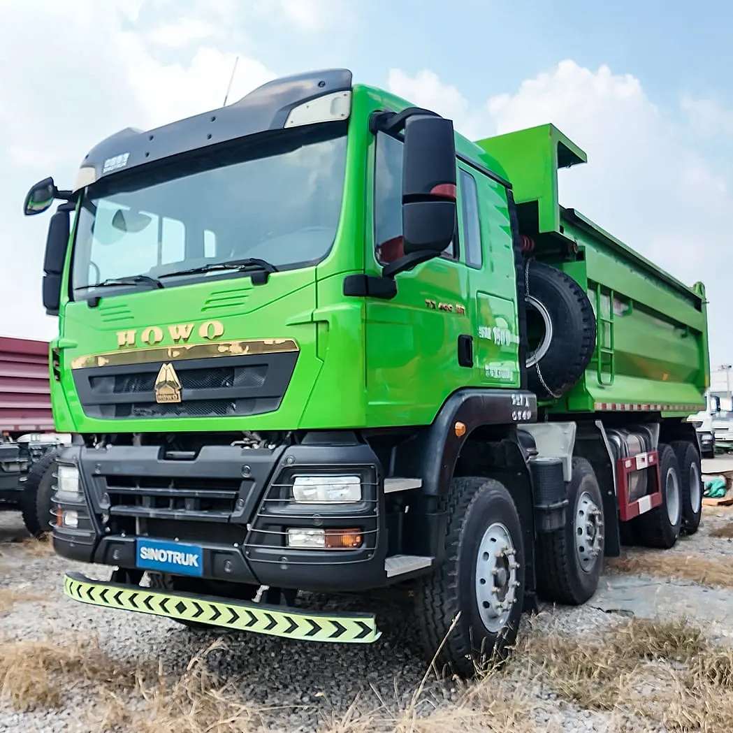 Used HOWO 8x4 dump truck in yellow with raised tipper body ready for export