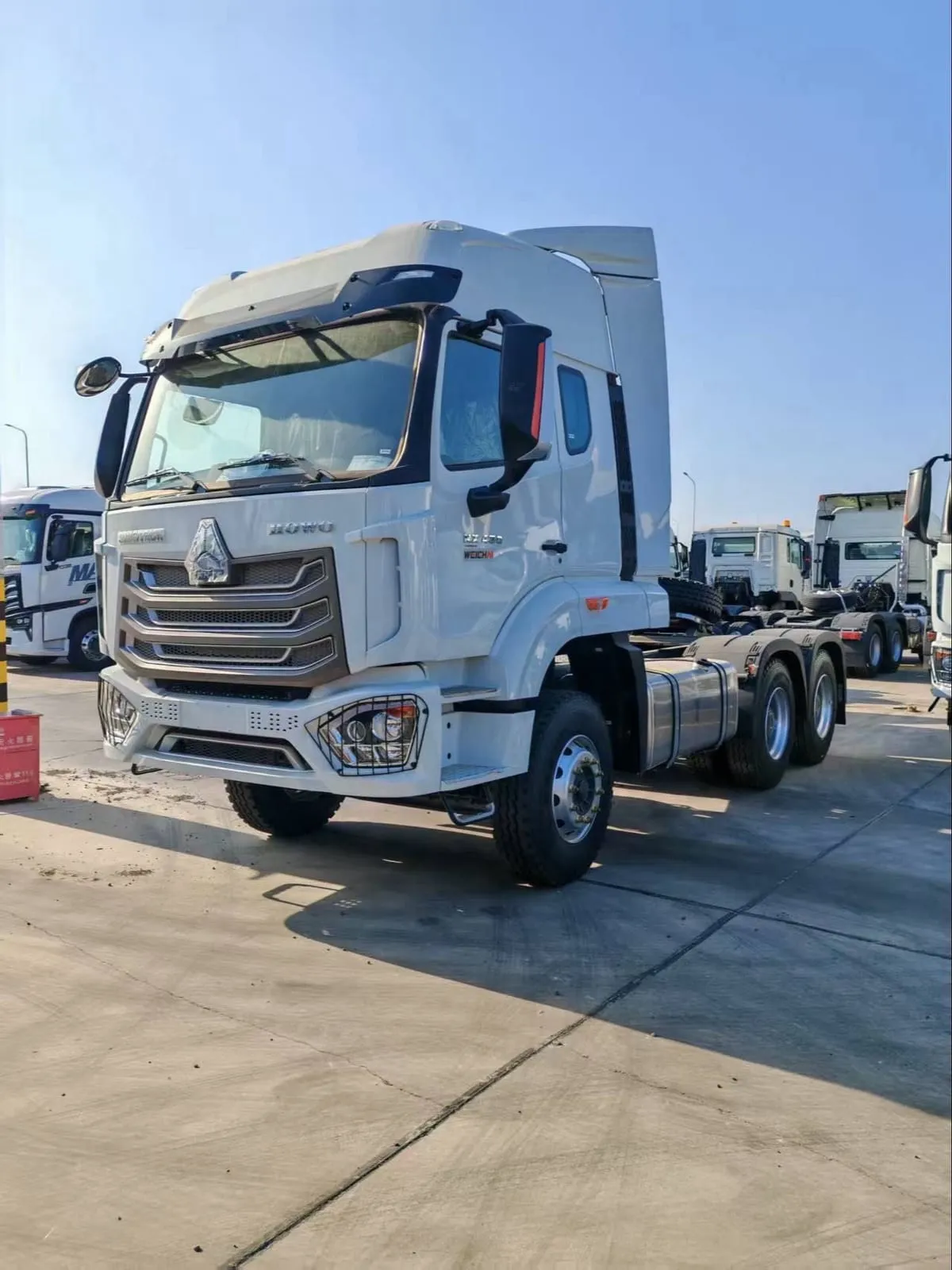 Used HOHAN 6x4 dump truck ready for export, red cab on yard in China