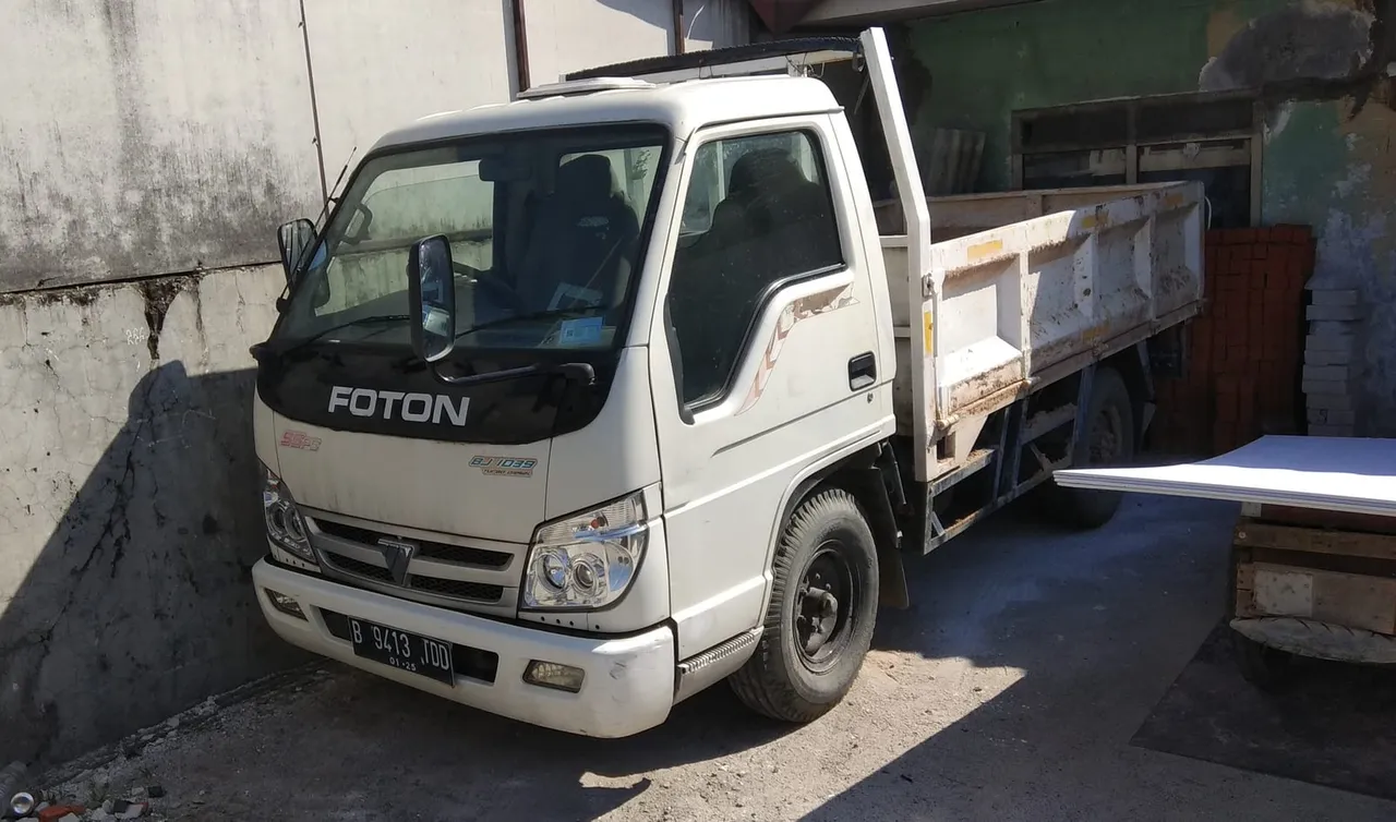 Camión volquete usado de 4 toneladas cargado con bloques de arena listo para entrega urbana